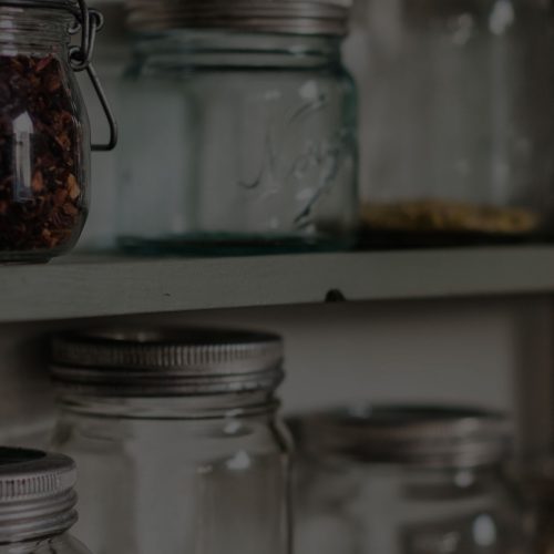 Glass mason jars on a shelf.