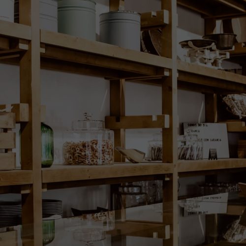 A wooden shelf in a room.