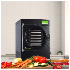 A food dehydrator in a kitchen is essential for emergency food storage with vegetables on a cutting board.