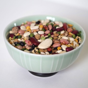 A bowl full of Rainy Day Foods Gluten-Free 16 Bean Mix - 5 Gallon 35 lbs Super Pail - 172 Servings - (SHIPS IN 5-10 WEEKS), peas and nuts.