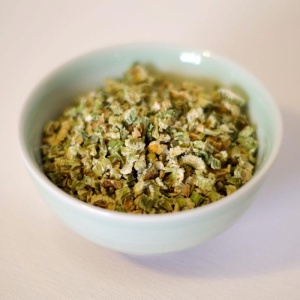 A bowl of greens in a white bowl.