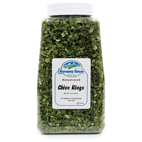 A jar of olive kings on a white background with Harmony House Dried Chives.