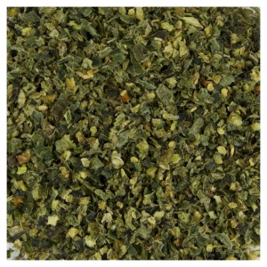 A plate with dried jalapeno dices (30 lbs) and green leaves.