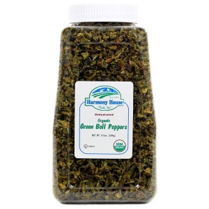 A jar of dried green bell peppers on a white background.