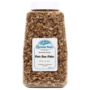 A jar of granola on a white background - pinto bean flakes.