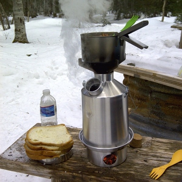 A pot of soup and bread on a table for emergency food storage.