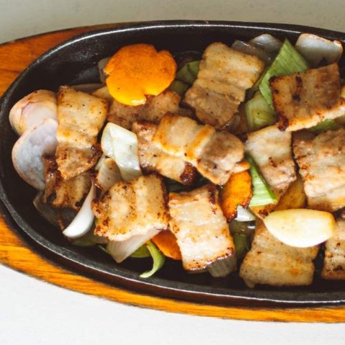 A skillet with meat and vegetables for emergency food storage.