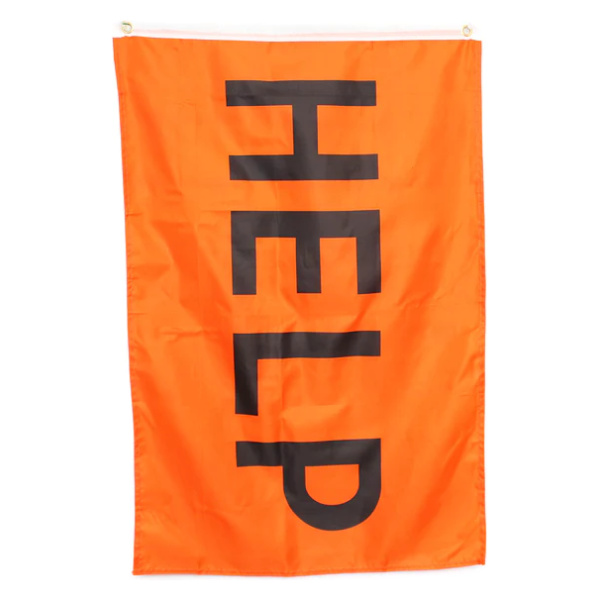 An orange flag with the word help on it, serving as an Emergency Help Signal.